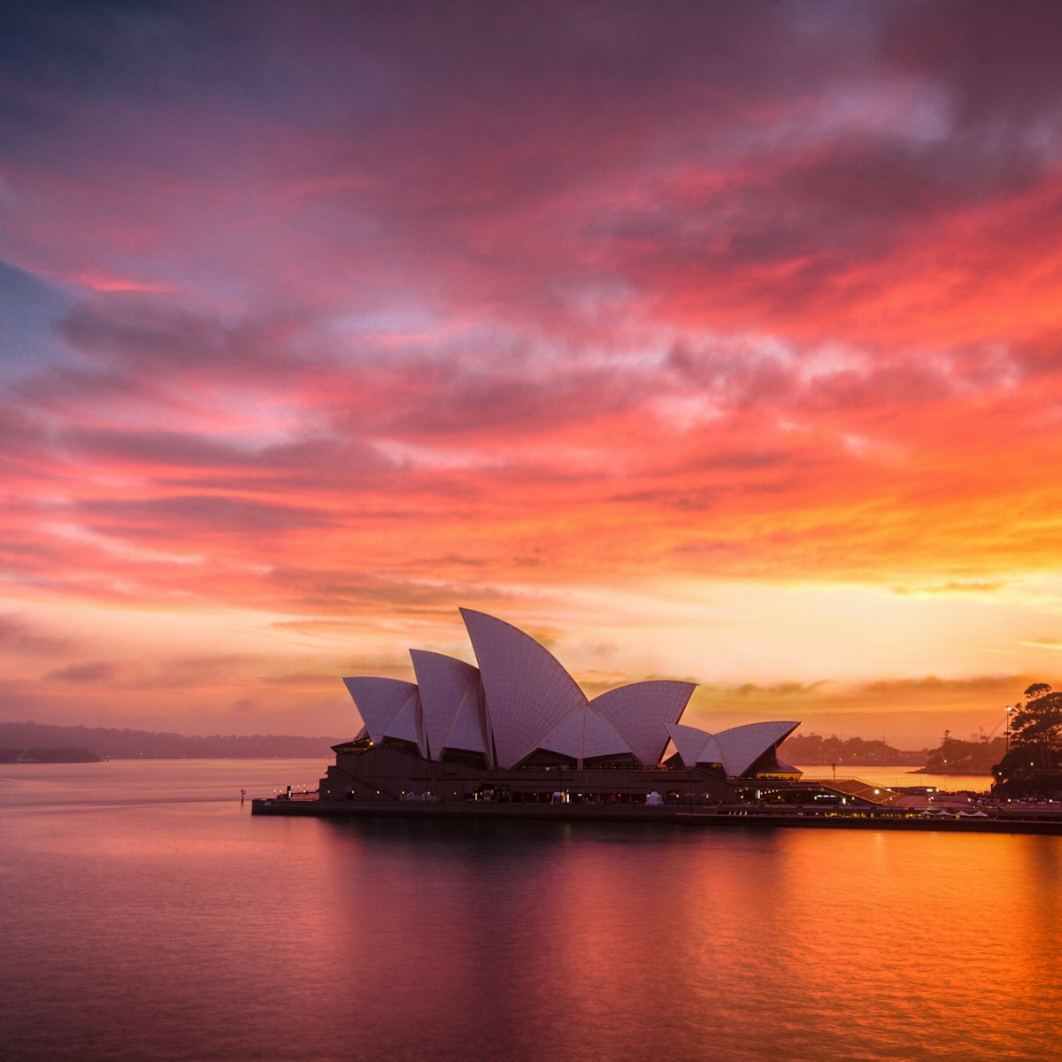 A burning dawn sky above the beautiful Sydney Opera House.