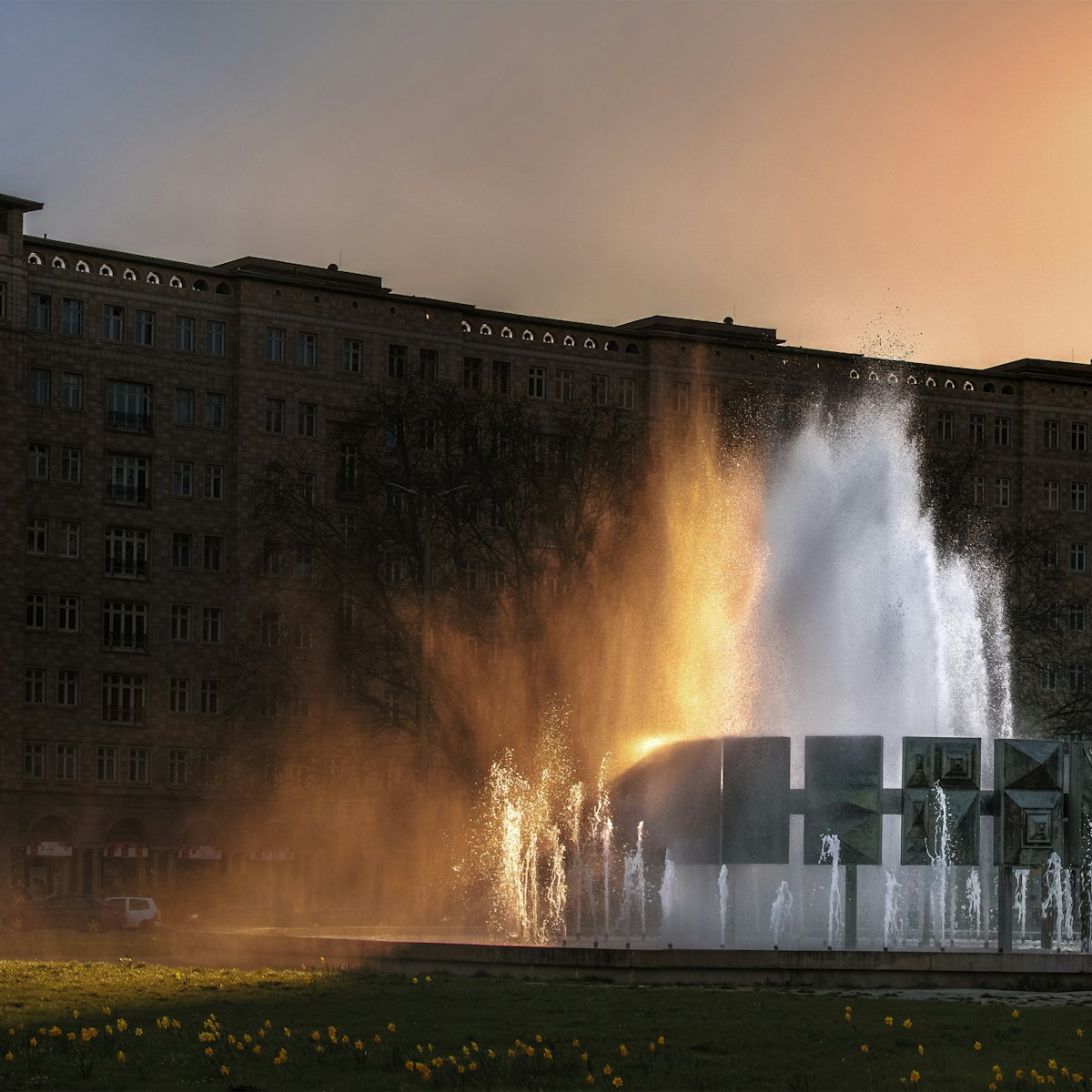 500px Photo ID: 109170205 - The grand fountain in Karl-Marx-Allee, Strausbergerplatz, .The setting sun colours the spray.