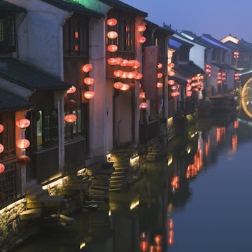 Traditional old riverside houses illuminated at night in Shantang water town, Suzhou, Jiangsu Province, China, Asia