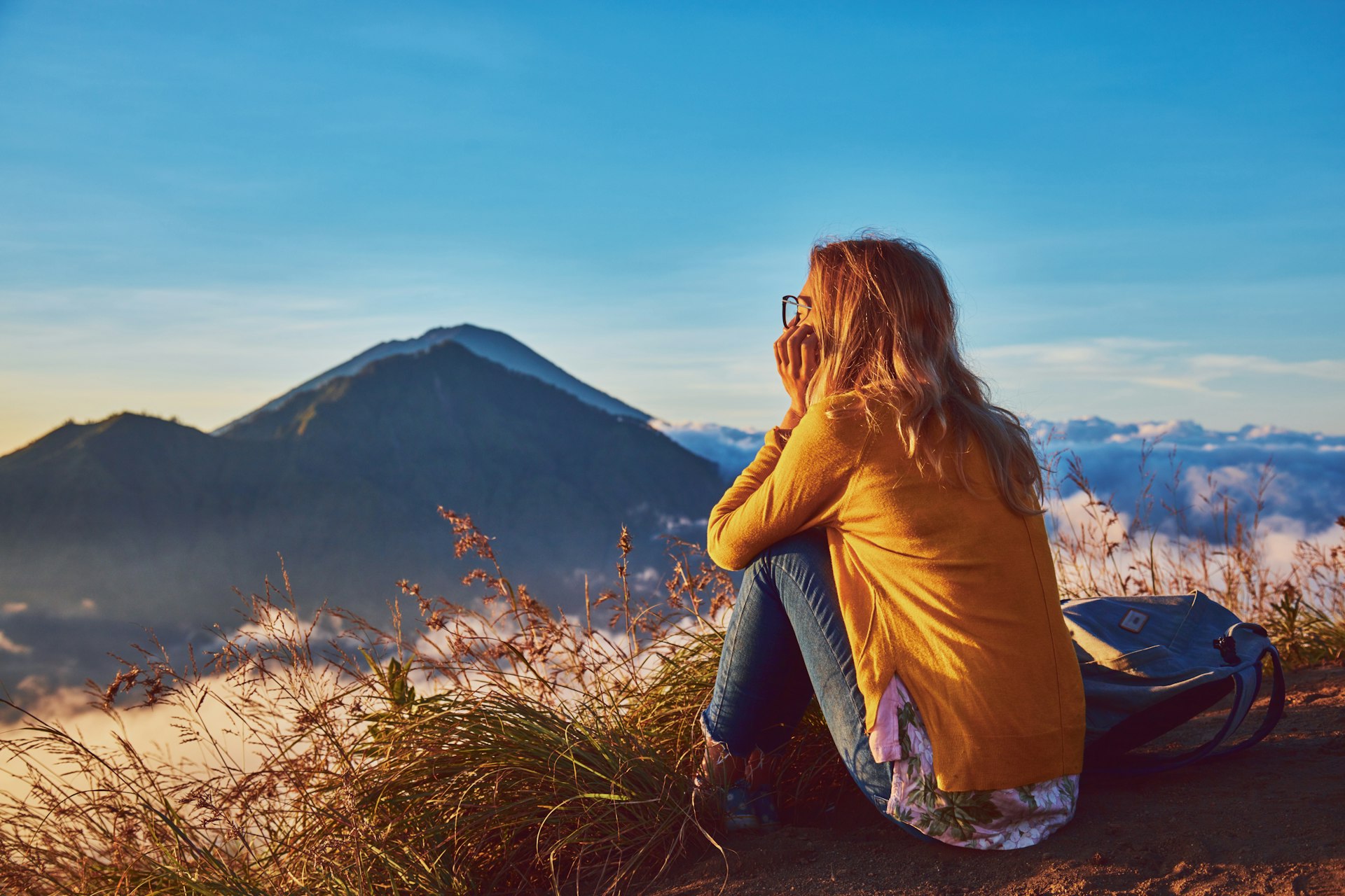 Woman watching the sun rise from the top of Mt Batur