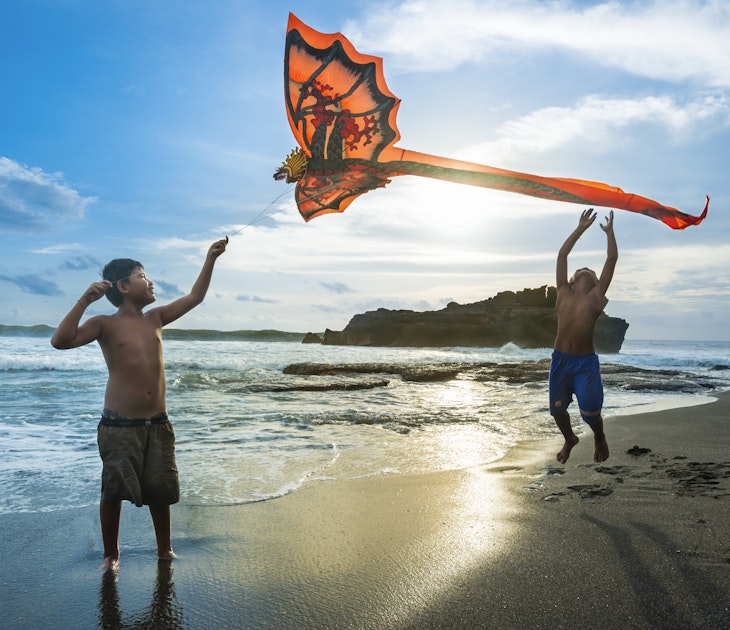 Kids playing with a kite at Tabanan village, Bali