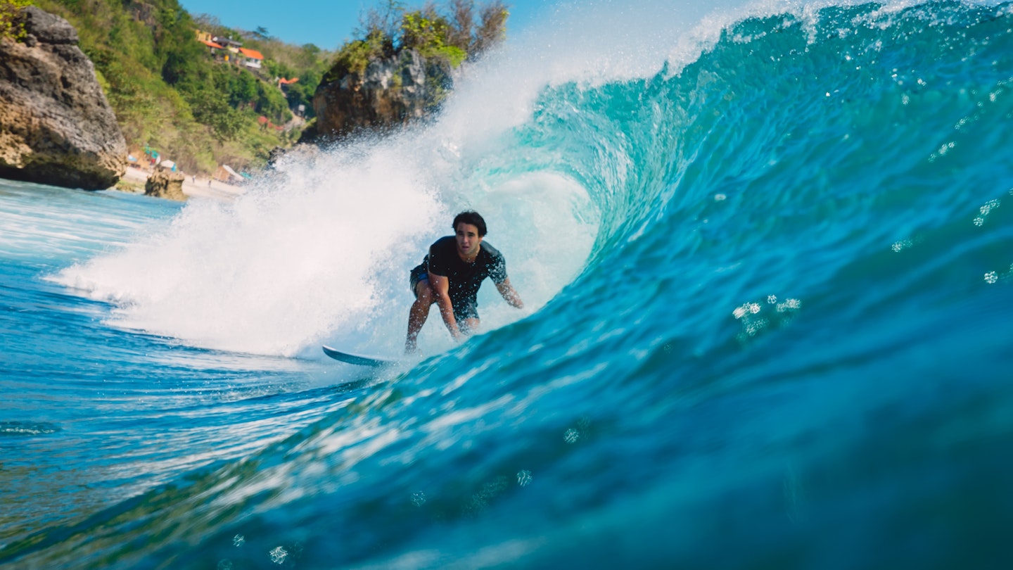 July 7, 2018: A male surfer inside the barrel of a wave at Padang Padang.